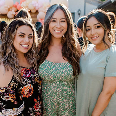 three girls smiling at camera